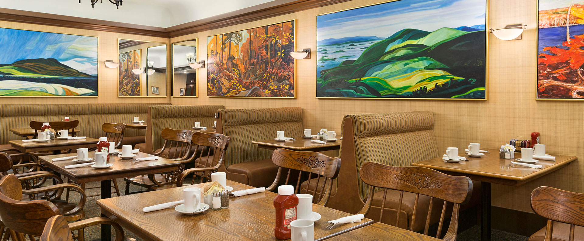 Chelsea's Restaurant, the onsite restaurant at Days Inn Vancouver Downtown is decorated with plush booths, leather seating and large colorful paintings.